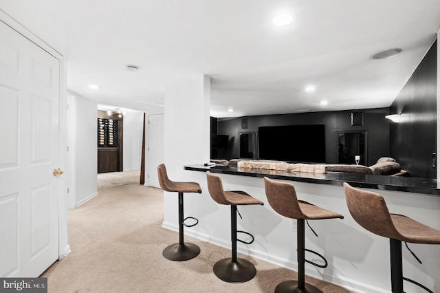 75 Bittersweet Dr, Doylestown, PA 18901 - kitchen featuring a kitchen breakfast bar, light colored carpet, dark countertops, recessed lighting, and a peninsula