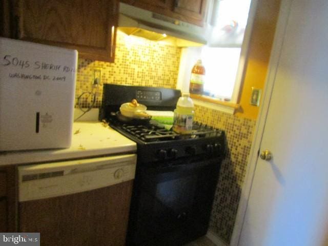 5045 Sheriff Rd NE, Washington, DC 20019 - kitchen with black range with gas cooktop, tasteful backsplash, and under cabinet range hood