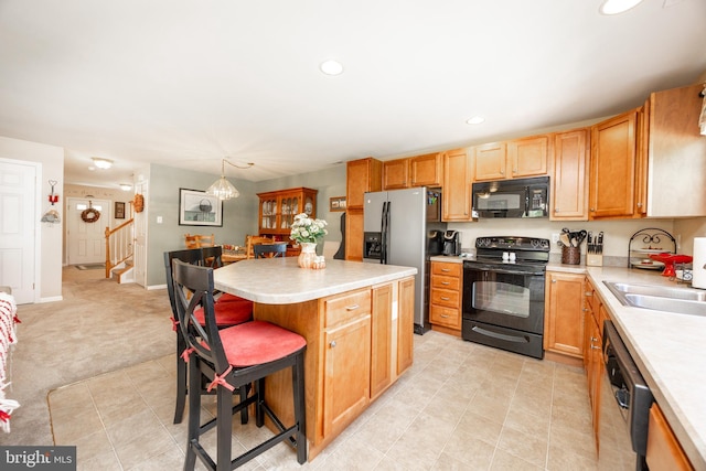 2751 Fynamore Ln, Downingtown, PA 19335 - kitchen featuring black appliances, light countertops, a breakfast bar, a center island, and recessed lighting