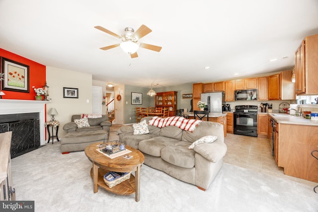 2751 Fynamore Ln, Downingtown, PA 19335 - living room with stairs, a ceiling fan, and a fireplace