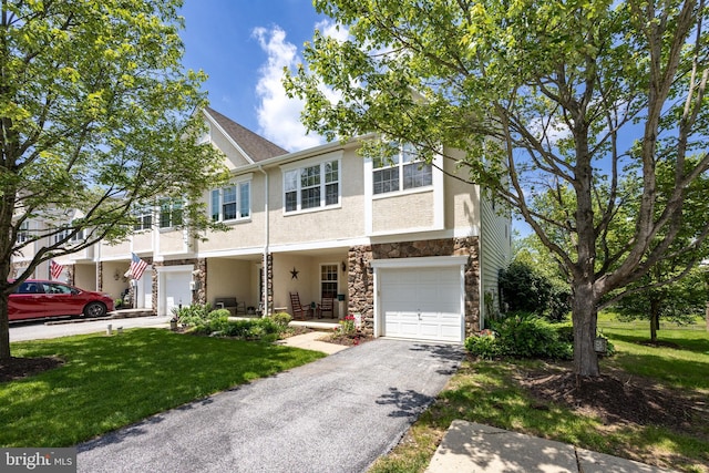 2751 Fynamore Ln, Downingtown, PA 19335 - view of property with stone siding, stucco siding, a garage, asphalt driveway, and a front lawn