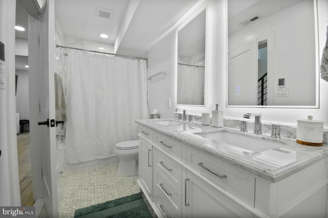 1427 K St SE, Washington, DC 20003 - bathroom with double vanity, shower / bath combo with shower curtain, recessed lighting, and tile patterned floors