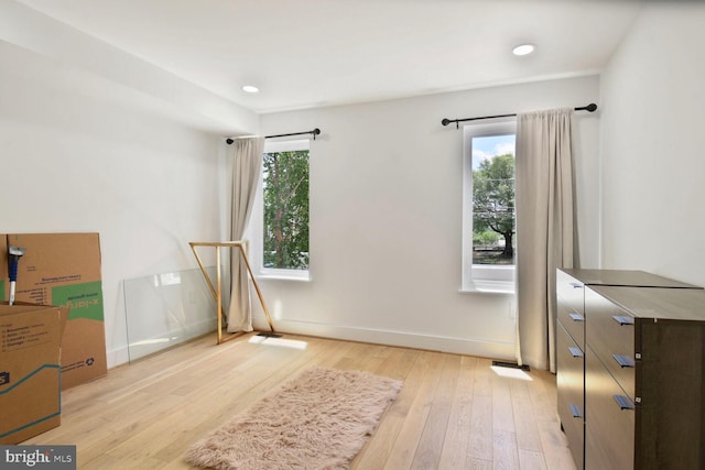 1427 K St SE, Washington, DC 20003 - unfurnished bedroom with multiple windows, light wood finished floors, and recessed lighting