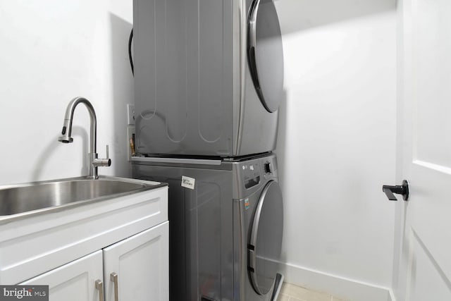 1427 K St SE, Washington, DC 20003 - laundry room with stacked washing machine and dryer, cabinet space, and light tile patterned floors