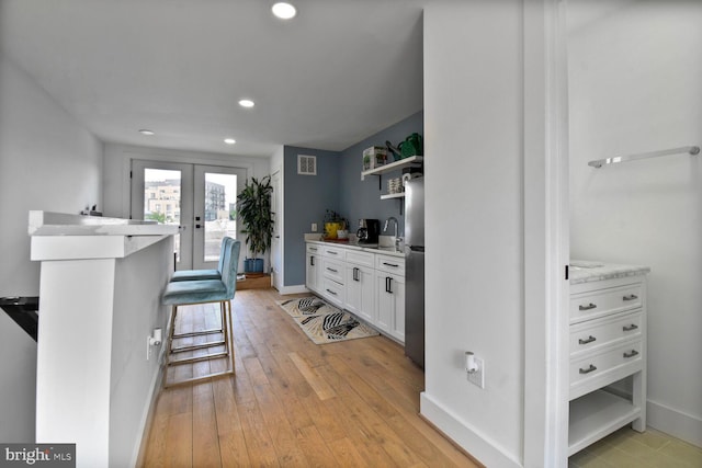 1427 K St SE, Washington, DC 20003 - kitchen featuring open shelves, white cabinetry, recessed lighting, light countertops, and light wood-type flooring