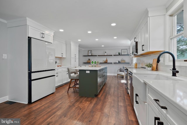 7728 Barnstable Pl, Rockville, MD 20855 - kitchen with stainless steel appliances, a breakfast bar area, recessed lighting, white cabinets, and backsplash