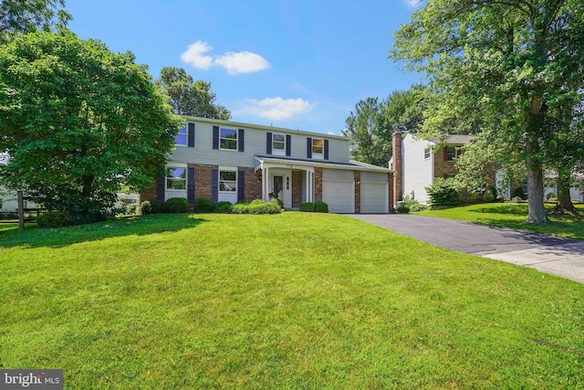 7728 Barnstable Pl, Rockville, MD 20855 - view of front of property with driveway, brick siding, a front yard, and an attached garage