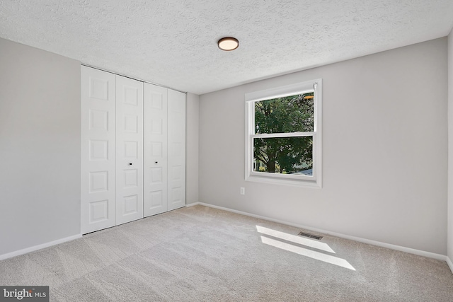 7728 Barnstable Pl, Rockville, MD 20855 - unfurnished bedroom with a textured ceiling, a closet, and carpet