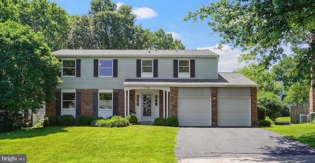 7728 Barnstable Pl, Rockville, MD 20855 - view of front of house with brick siding, asphalt driveway, and a front lawn