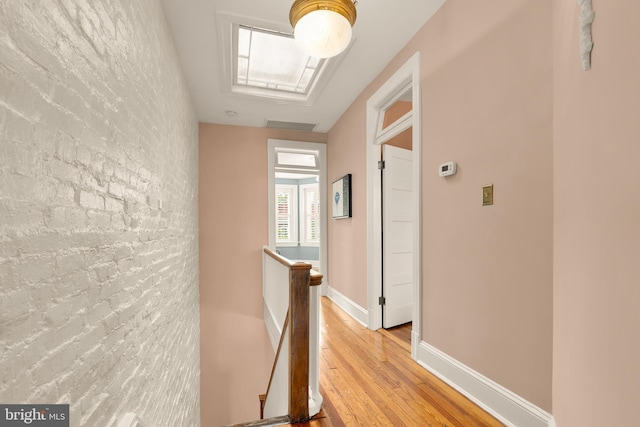 61 W St NW, Washington, DC 20001 - hall with an upstairs landing, light wood-style flooring, an accent wall, and a skylight