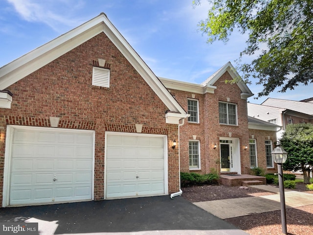 12054 Greatbridge Rd, Woodbridge, VA 22192 - view of front of home featuring asphalt driveway, brick siding, and an attached garage