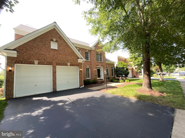 12054 Greatbridge Rd, Woodbridge, VA 22192 - view of front of home featuring driveway, brick siding, and an attached garage
