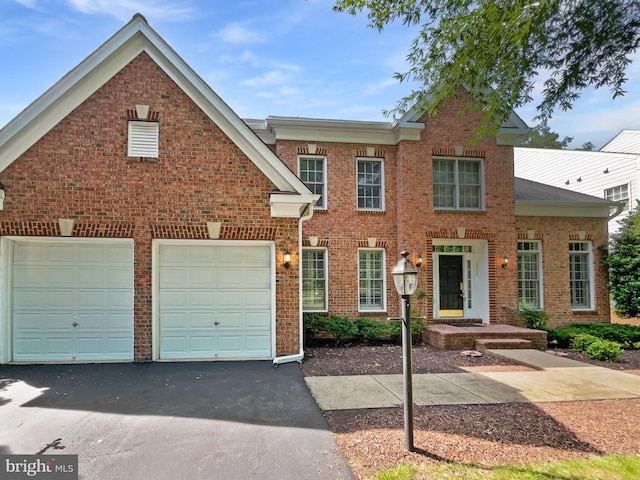12054 Greatbridge Rd, Woodbridge, VA 22192 - view of front of property with asphalt driveway, a garage, and brick siding