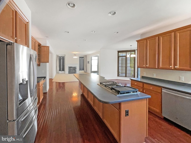 12054 Greatbridge Rd, Woodbridge, VA 22192 - kitchen with appliances with stainless steel finishes, dark countertops, dark wood-style floors, brown cabinets, and open floor plan