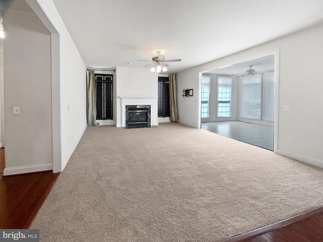 12054 Greatbridge Rd, Woodbridge, VA 22192 - unfurnished living room with a ceiling fan, a premium fireplace, carpet flooring, and wood finished floors