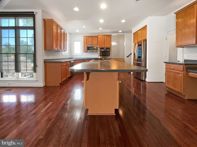 12054 Greatbridge Rd, Woodbridge, VA 22192 - kitchen with appliances with stainless steel finishes, dark countertops, dark wood-style floors, a center island, and recessed lighting