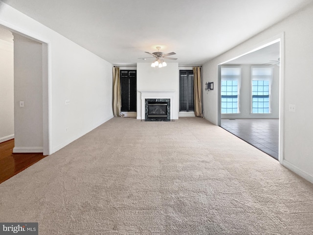 12054 Greatbridge Rd, Woodbridge, VA 22192 - unfurnished living room with carpet floors, ceiling fan, a premium fireplace, and tile patterned flooring