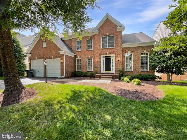 12054 Greatbridge Rd, Woodbridge, VA 22192 - view of front of home with brick siding, a front yard, driveway, and roof with shingles