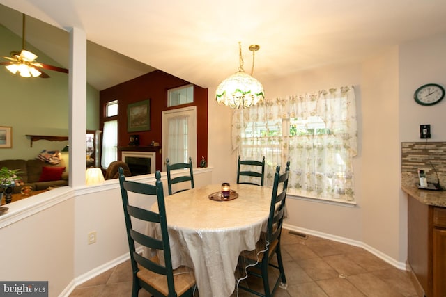 9 Stirrup Way, Burlington, NJ 08016 - tiled dining space featuring ceiling fan, a chandelier, and a fireplace