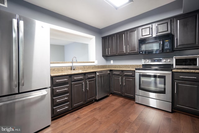 10248 Appalachian Cir Unit 1-D7, Oakton, VA 22124 - kitchen featuring appliances with stainless steel finishes, dark wood-style floors, and light stone countertops
