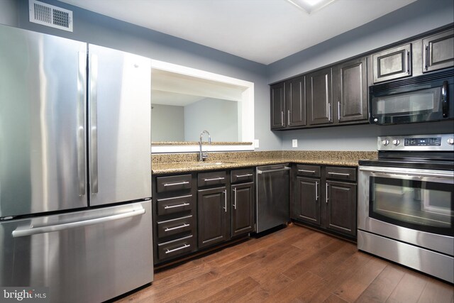 10248 Appalachian Cir Unit 1-D7, Oakton, VA 22124 - kitchen with stainless steel appliances, dark wood-style flooring, and light stone countertops