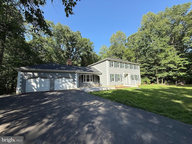 4910 Stonehurst Dr, Woodbridge, VA 22192 - colonial house with asphalt driveway, an attached garage, a chimney, and a front lawn