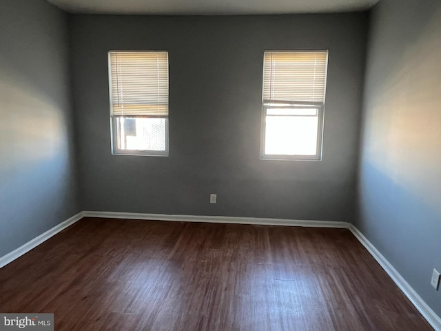 1819 Presstman St, Baltimore, MD 21217 - empty room with dark wood-type flooring and healthy amount of natural light