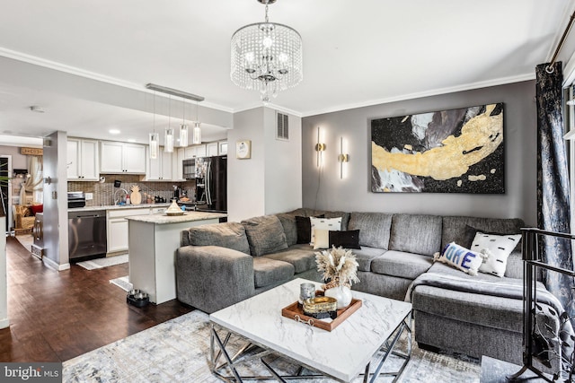 116 Lake Arrowhead Cir, Bear, DE 19701 - living room with dark wood finished floors, ornamental molding, and a chandelier