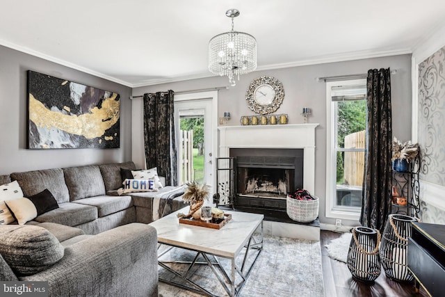 116 Lake Arrowhead Cir, Bear, DE 19701 - living room featuring healthy amount of natural light, crown molding, a fireplace with raised hearth, wood finished floors, and a chandelier