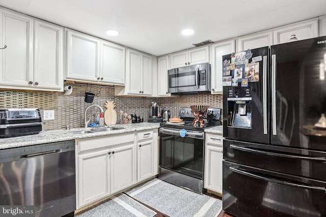 116 Lake Arrowhead Cir, Bear, DE 19701 - kitchen featuring appliances with stainless steel finishes, tasteful backsplash, and white cabinets