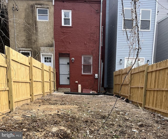 1030 N Fulton Ave, Baltimore, MD 21217 - back of house with a fenced backyard and entry steps