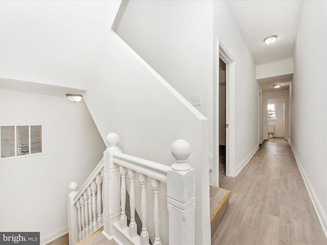 1030 N Fulton Ave, Baltimore, MD 21217 - hallway with an upstairs landing and light wood-style floors