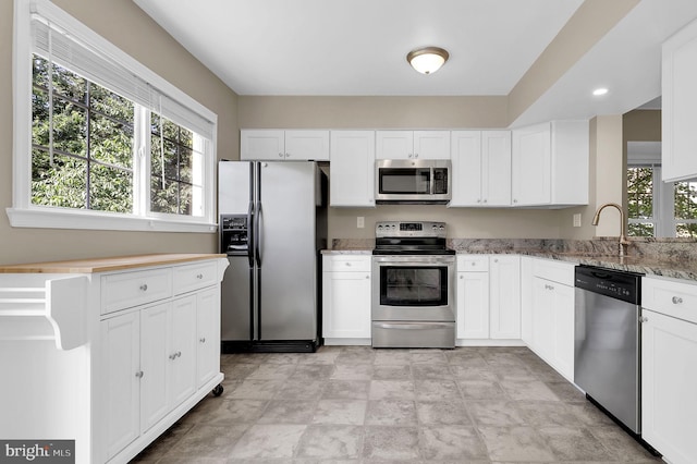 8916 Rosewood Way, Jessup, MD 20794 - kitchen with appliances with stainless steel finishes, light stone countertops, and white cabinetry