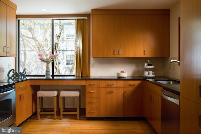 33 Sergeant St, Princeton, NJ 08540 - kitchen with stainless steel appliances, light wood finished floors, tasteful backsplash, brown cabinets, and recessed lighting