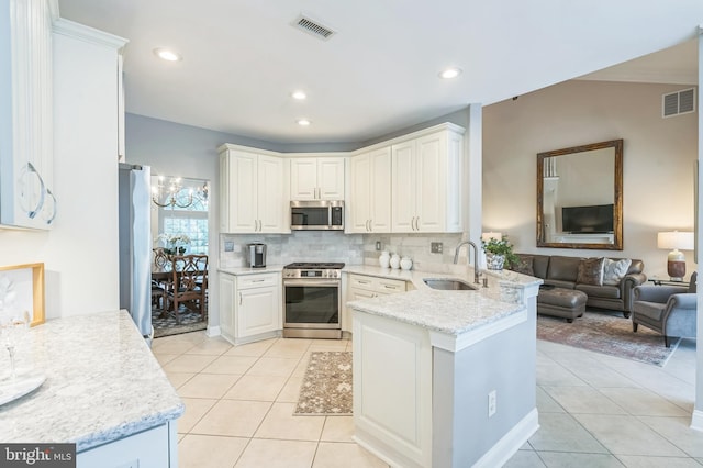 1 Springfield Ave, Berlin, NJ 08009 - kitchen with appliances with stainless steel finishes, a peninsula, light tile patterned floors, decorative backsplash, and recessed lighting