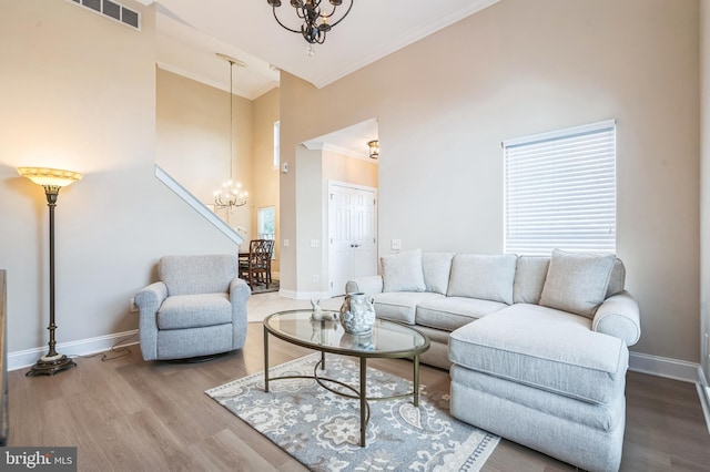 1 Springfield Ave, Berlin, NJ 08009 - living area featuring a chandelier, ornamental molding, high vaulted ceiling, and wood finished floors