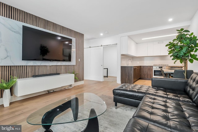 37 L St SE Unit 101, Washington, DC 20003 - living area with a barn door, light wood-style floors, recessed lighting, and an accent wall