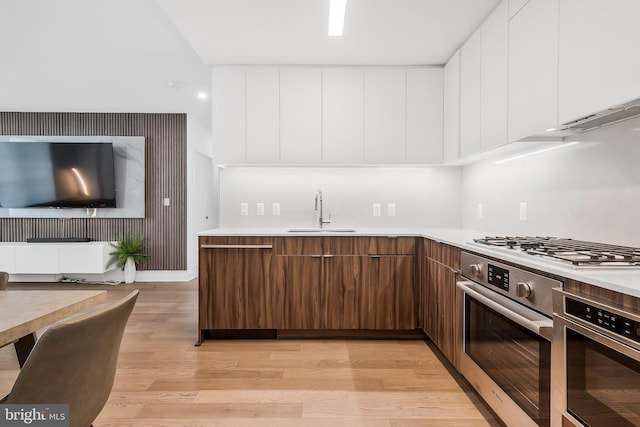 37 L St SE Unit 101, Washington, DC 20003 - kitchen featuring stainless steel oven, light wood-style flooring, and modern cabinets