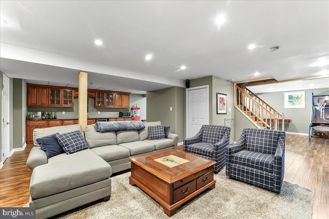 11 Georges Way, Glen Mills, PA 19342 - living room with bar with sink, light wood finished floors, stairs, and recessed lighting