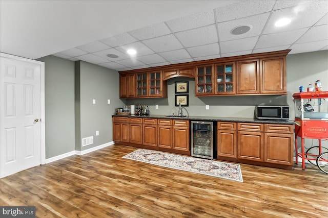11 Georges Way, Glen Mills, PA 19342 - indoor wet bar featuring beverage cooler, stainless steel microwave, wood finished floors, and a drop ceiling