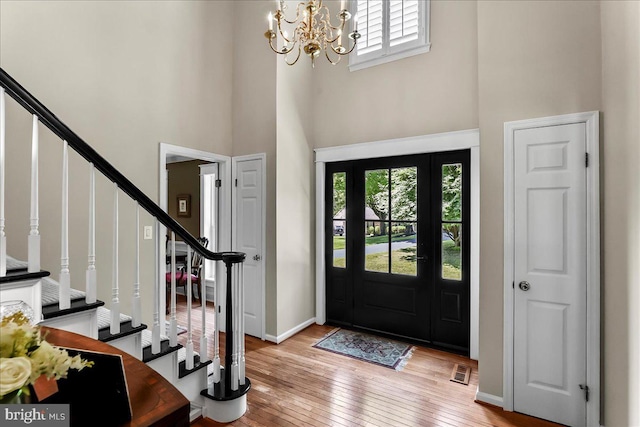 11 Georges Way, Glen Mills, PA 19342 - foyer entrance featuring a high ceiling, plenty of natural light, a chandelier, light wood-style flooring, and stairs