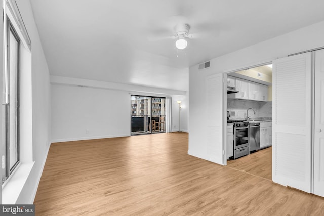 3100 S Manchester St Unit 827, Falls Church, VA 22044 - unfurnished living room with a ceiling fan and light wood-style flooring