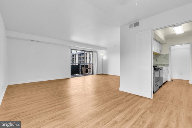 3100 S Manchester St Unit 827, Falls Church, VA 22044 - unfurnished living room with light wood-style floors and baseboards