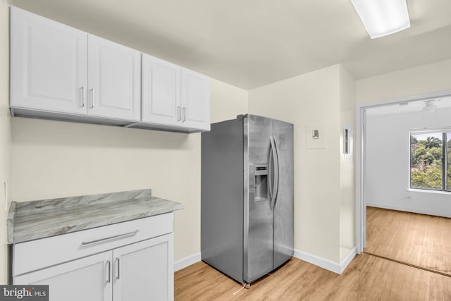 3100 S Manchester St Unit 827, Falls Church, VA 22044 - kitchen with stainless steel fridge with ice dispenser, light wood finished floors, and white cabinetry