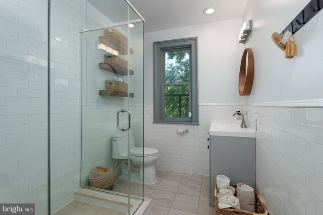 46 Park Pl Unit 3, Princeton, NJ 08542 - bathroom featuring tile walls, vanity, a shower stall, tile patterned floors, and wainscoting