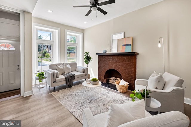 2011 Boone St, Baltimore, MD 21218 - living room featuring wood finished floors, a fireplace, a ceiling fan, and recessed lighting