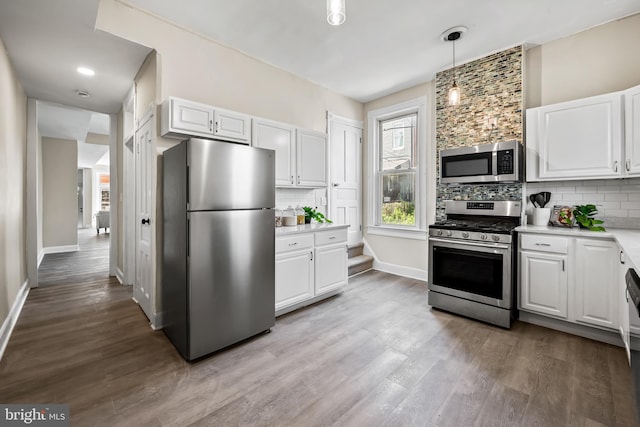 2011 Boone St, Baltimore, MD 21218 - kitchen featuring appliances with stainless steel finishes, wood finished floors, and backsplash