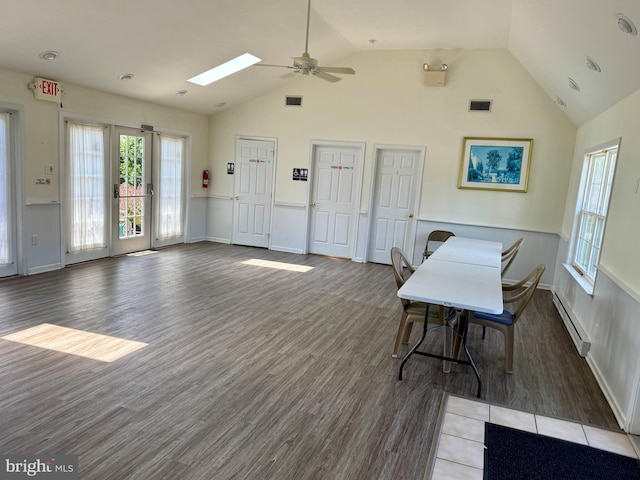 101 Lexington Way, Morgantown, PA 19543 - dining room featuring a baseboard radiator, wood finished floors, a ceiling fan, high vaulted ceiling, and a skylight