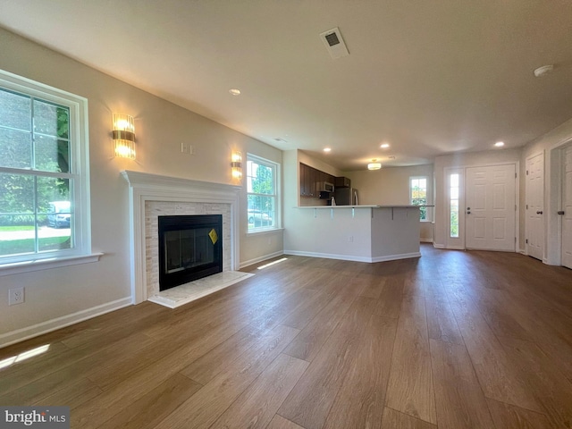 101 Lexington Way, Morgantown, PA 19543 - unfurnished living room with wood finished floors, plenty of natural light, recessed lighting, and a stone fireplace