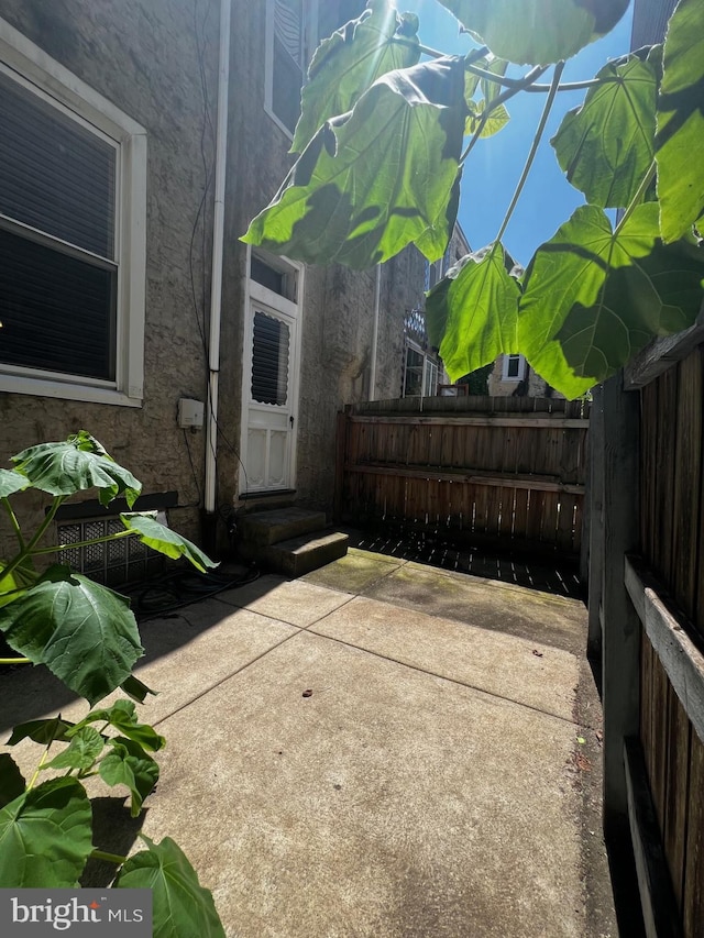 453 Belgrade St, Philadelphia, PA 19125 - doorway to property featuring stucco siding and a patio area